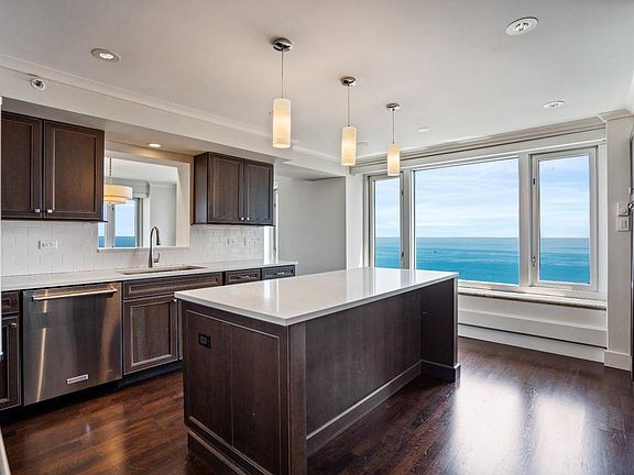 Peek-a-boo window above sink allows views North of Lincoln Park from kitchen sink.