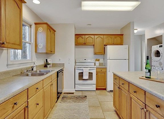 Kitchen seen from dining area. Small hallway to two bedrooms can be seen on the right with Bosch washer and dryer.