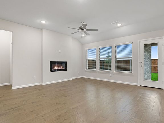 Living room in the Pulitzer home plan by Trophy Signature Homes - REPRESENTATIVE PHOTO