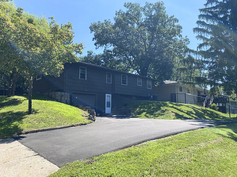 Back of home, tuck under single stall garage and additional parking pad.