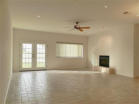 Custom tile in living room overlooking acreage.