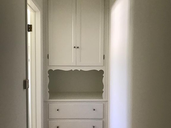 Hallway with linen cabinets