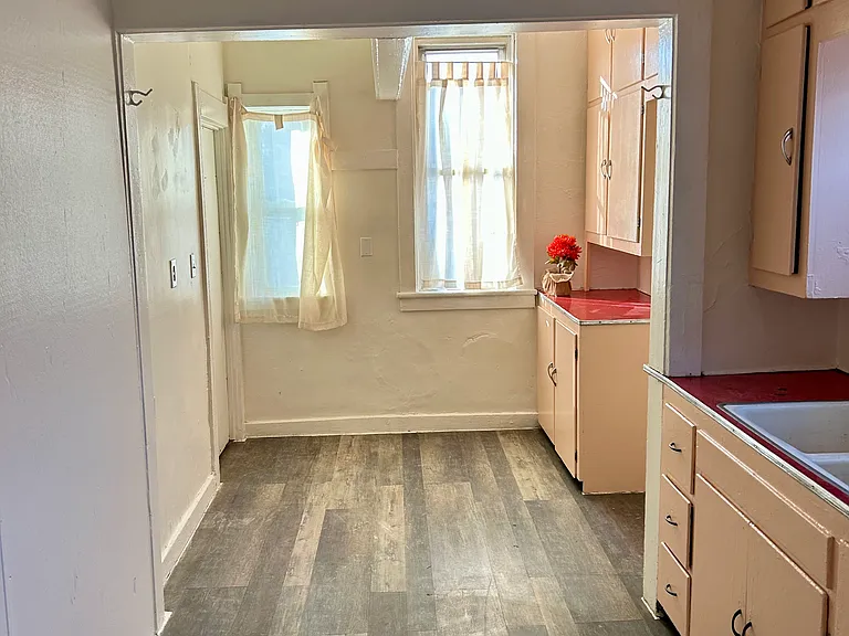 Long view kitchen entrance to basement at far left