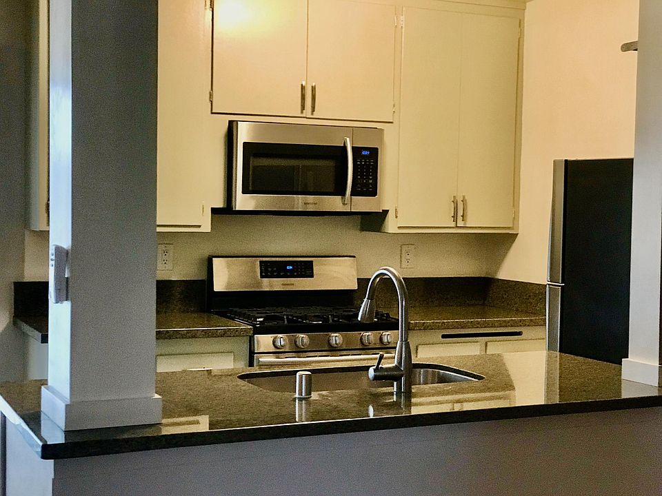 Open kitchen island with new stainless upgraded appliances.
