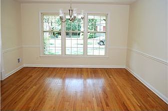 Formal dining room with chandelier and chair rail