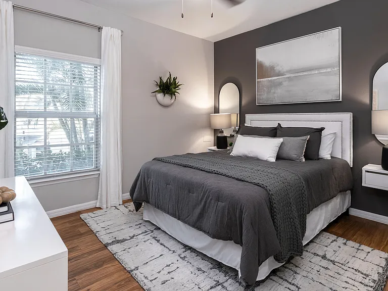 Unwind in this beautifully designed bedroom, featuring wood-style flooring, multi-speed ceiling fan, and a spacious closet.