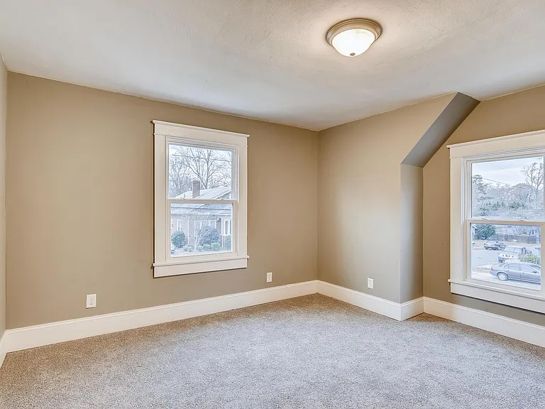 Two upstairs bedrooms mirror each other.