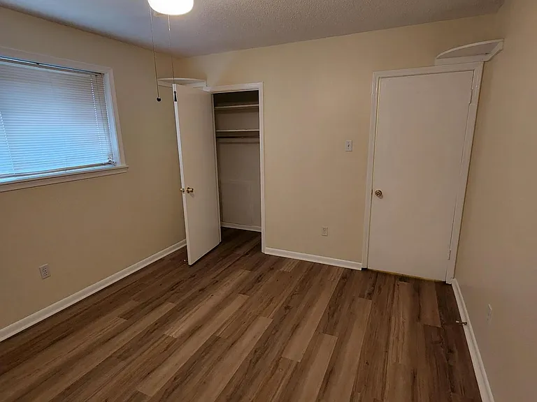 Right BR showing closet door, closet includes hanger and shelving
