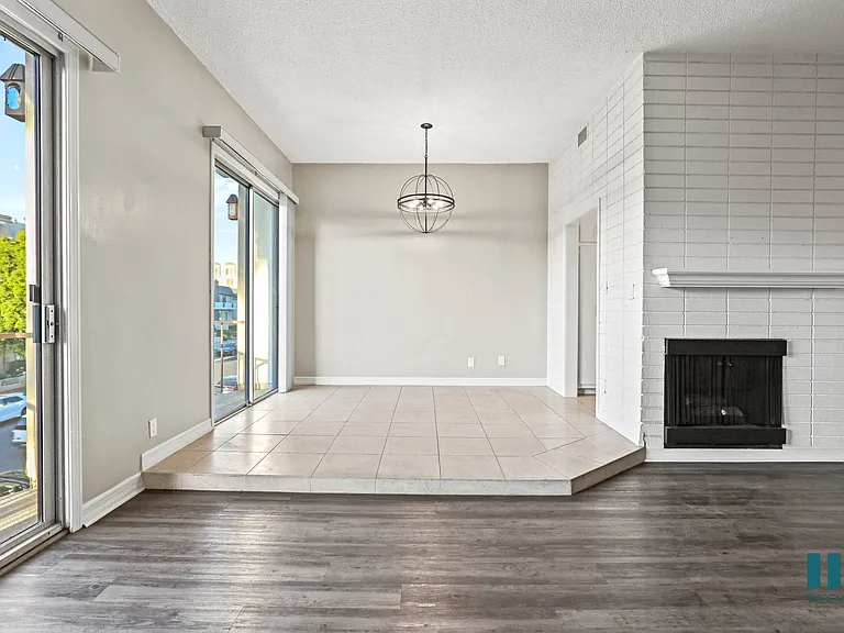 Open-Concept Living Room and Dining Room Space with Balcony and Double Glass Doors