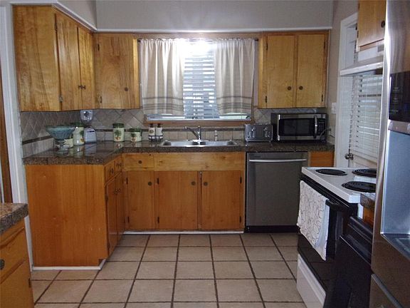 Well lit tile kitchen.