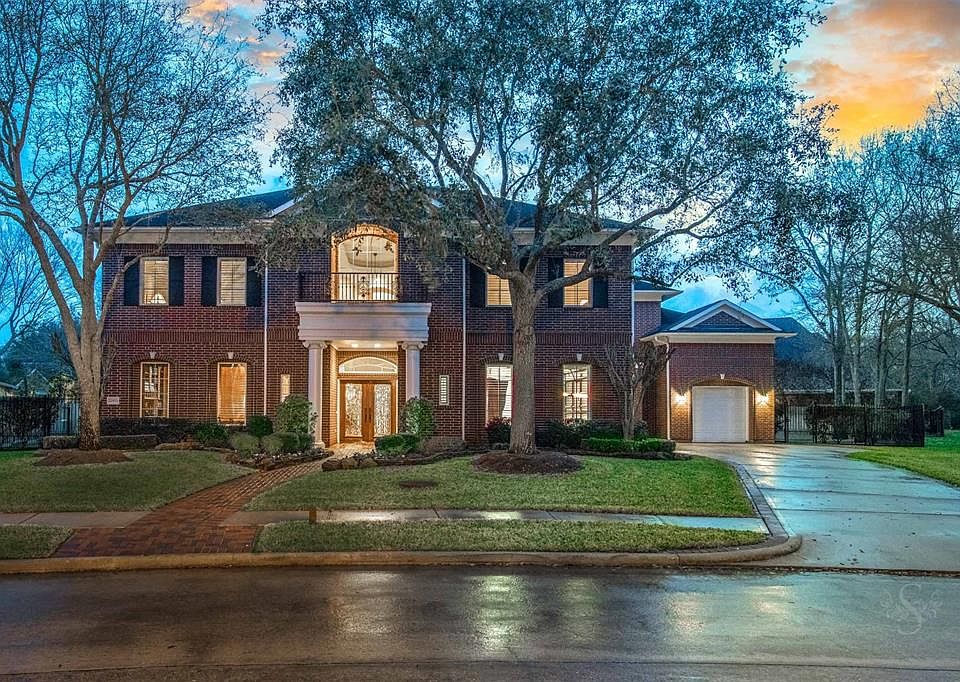 A winning marriage of luxury, privacy and perfection. BBHGRE is proud to present this custom executive home tucked away in the gated neighborhood of Bayou Oaks located in the heart of Cinco Ranch. The property is situated on a 23,085SF lot siding to 