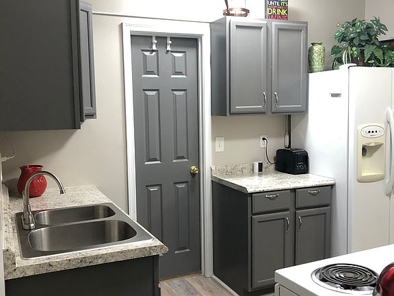 Kitchen is small but sufficient. Includes stacked washer and dryer but no dishwasher.