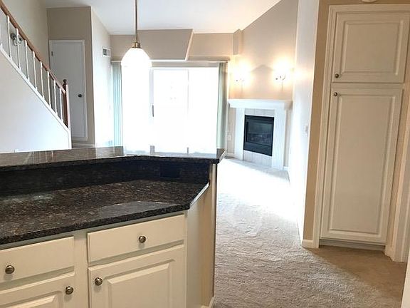 Kitchen looking into living room and out to 4 season room.