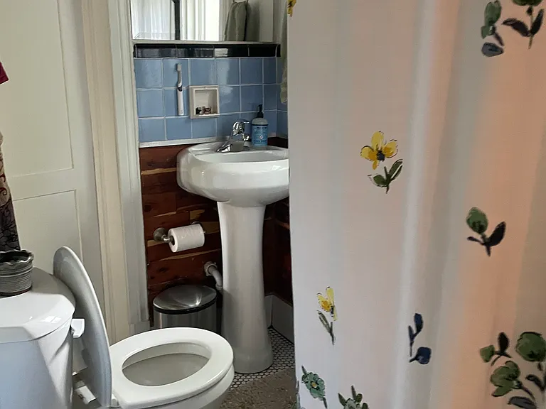 Bathroom view of shower and sink.