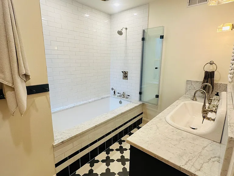 Bathroom #1 with oversized soaking tub, rain and standard shower heads, and double sink