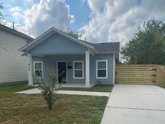 Front of home with new drive-in gate.