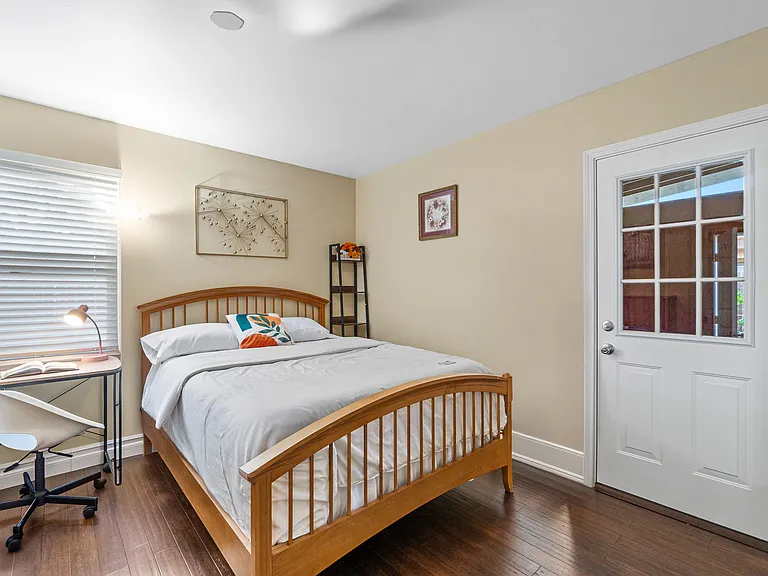 Rest and work comfortably in a bedroom with a desk area.