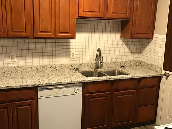 Granite counter tops w/ white tiled backsplash/tile planked flooring. new stainless steel appliances to be installed