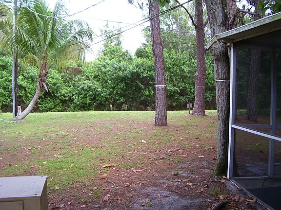 Pleasant, wooded backyard with sceened room.