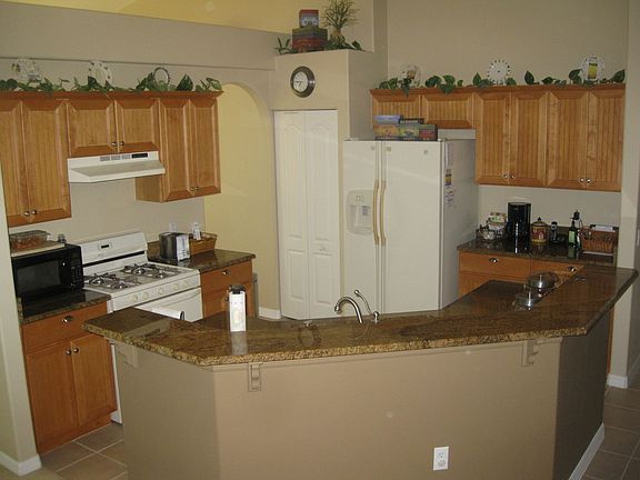 kitchen with granite tops and maple bead board cabinets
