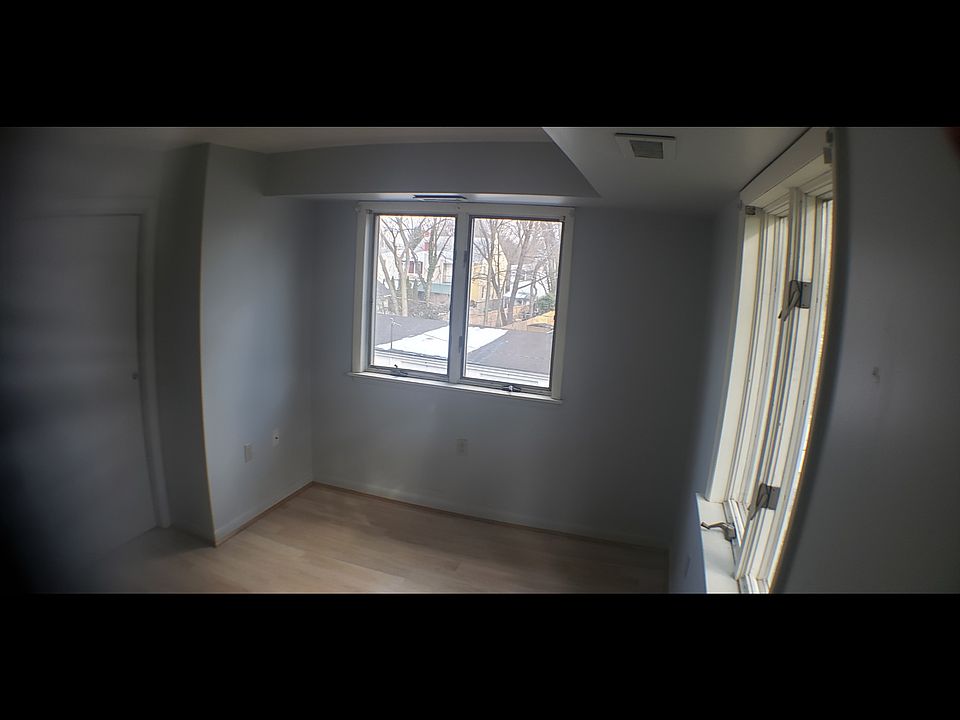 Bedroom view showing windows on two walls. Double closet is on the left; only one of the 4 doors to the closet is shown here.
