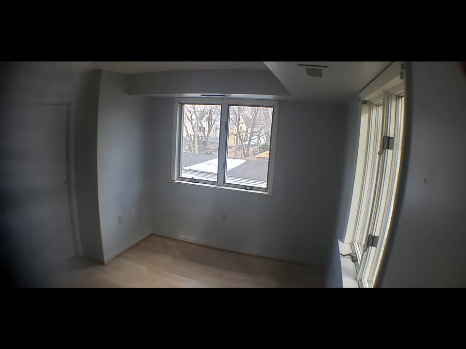 Bedroom view showing windows on two walls. Double closet is on the left; only one of the 4 doors to the closet is shown here.