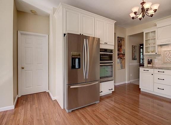 Cook's Dream Kitchen!  Stainless appliances, wood floors, custom tilework and granite counters