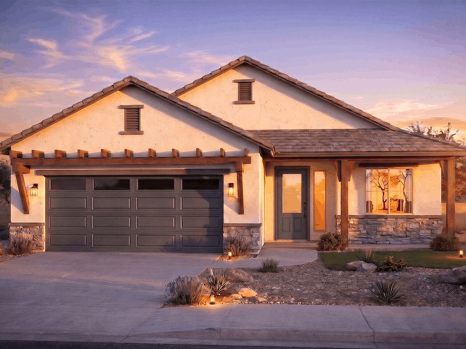 A modern single-story house with a two-car garage, stone accents, a covered porch, and landscaped fr