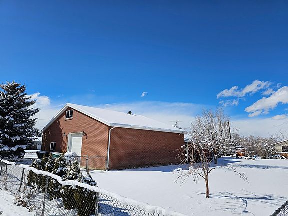 Picture of the back yard and view of the back of garage.