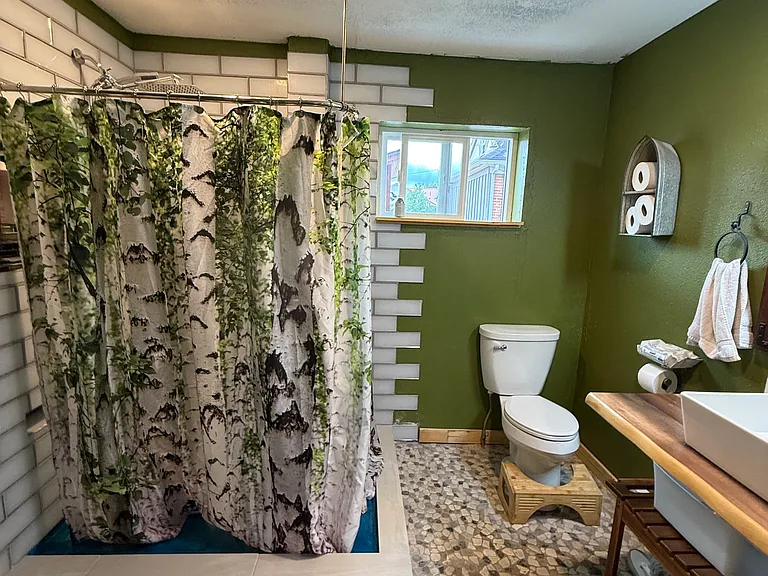 Spacious bathroom with shower large vanity and storage space