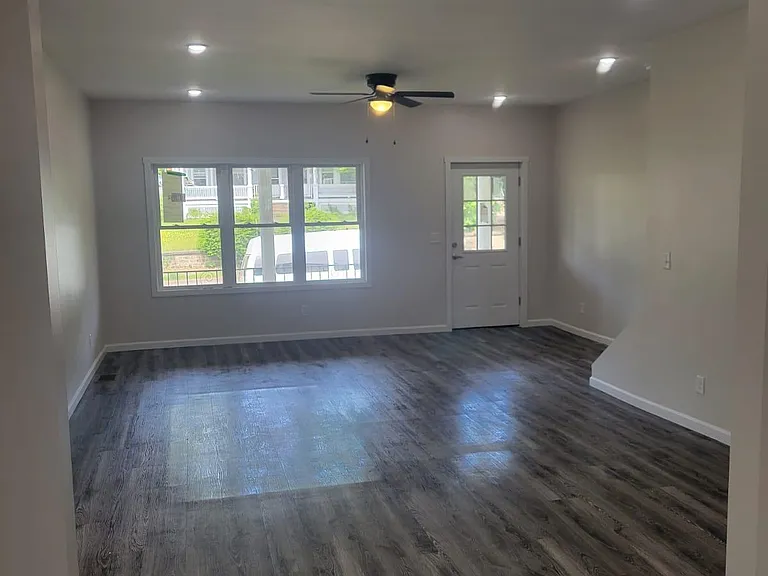 Open concept living and dining rooms, new windows & high ceilings.