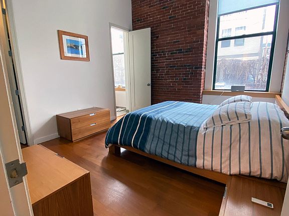 Master bedroom with 12 ft. ceilings and 10 ft. window and walk in closet