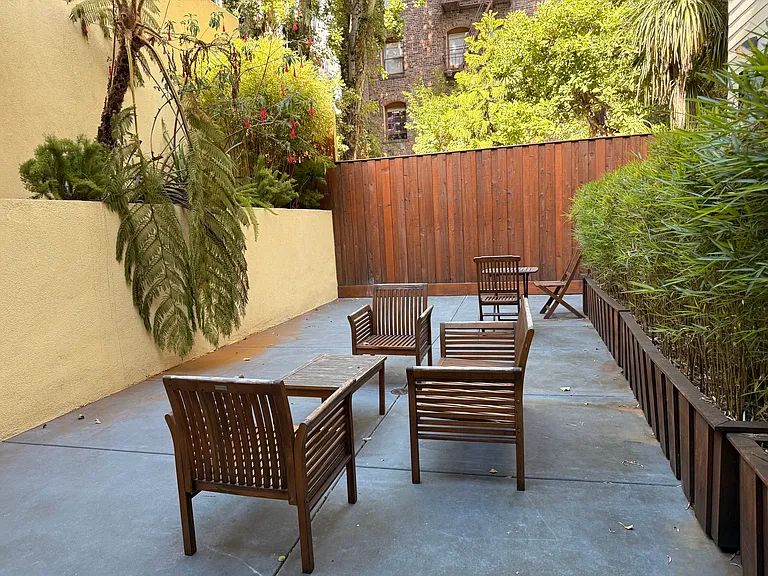 Enjoy a sunlit shared patio where hummingbirds frequently stop by.
