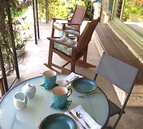 Table and chairs on front porch for coffee or happy hour