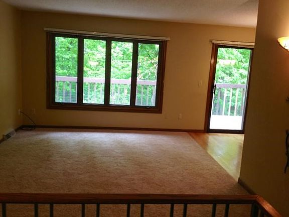 Living room view adjacent to kitchen with sliding glass doors to walkout to the spacious extended deck.