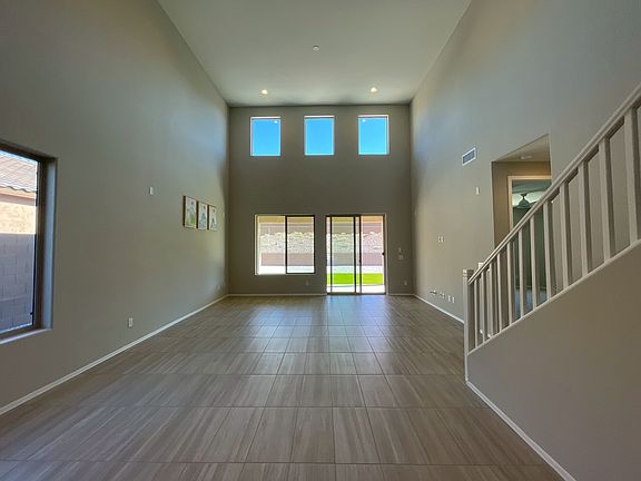 Spacious living area with soaring ceilings and a modern open kitchen.