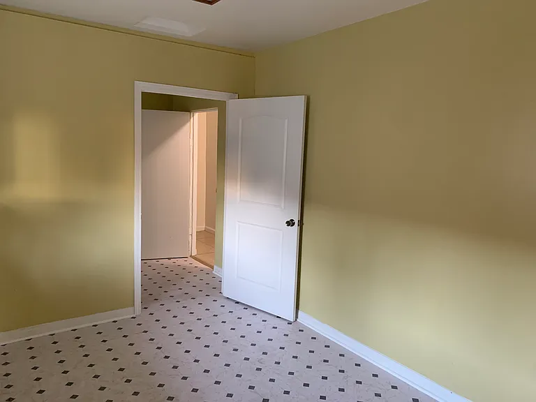 View from kitchen looking into dedicated laundry room with hook-ups and side door entrance to house.