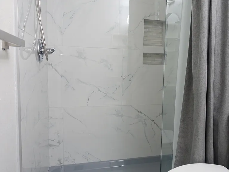 Bathroom #1: Recessed shower cubby. Glass splashguard