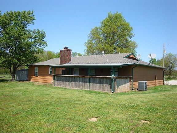 View from SE corner showing rustic, country covered, partially enclosed patio.