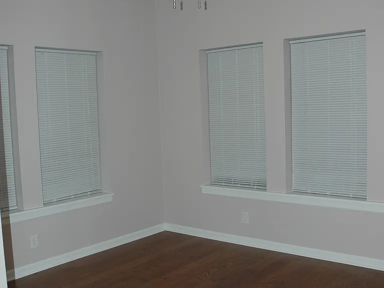 Secondary bedroom with ceiling fan and lots of natural light.