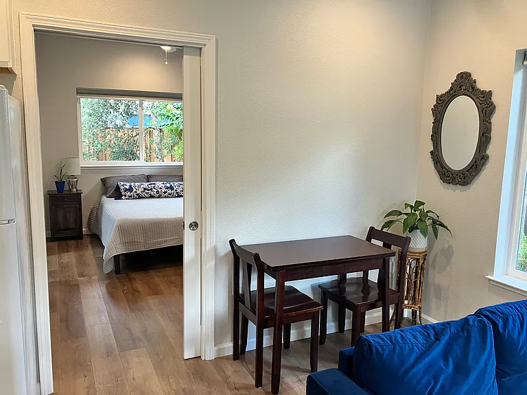 View of the hallway leading through the pocket door to the bathroom and bedroom from the living area.