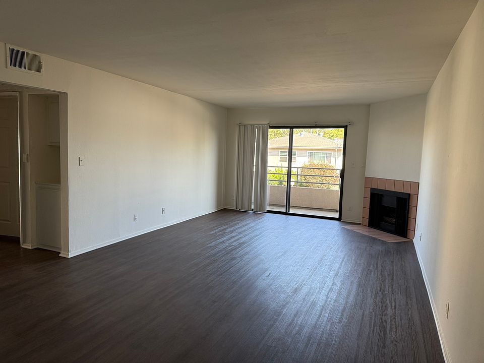 Massive living room with fireplace and private balcony