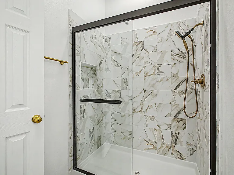 Primary bathroom with renovated walk-in shower. All new tile and fixtures.