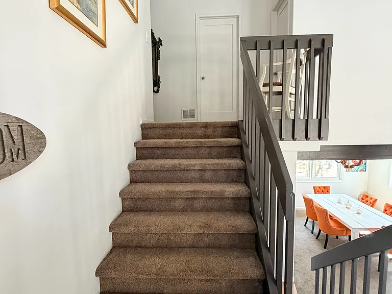 Stairs leading upstairs to master bedroom/bathroom as well as 2 additional bedrooms and full bath serving 2 bedrooms