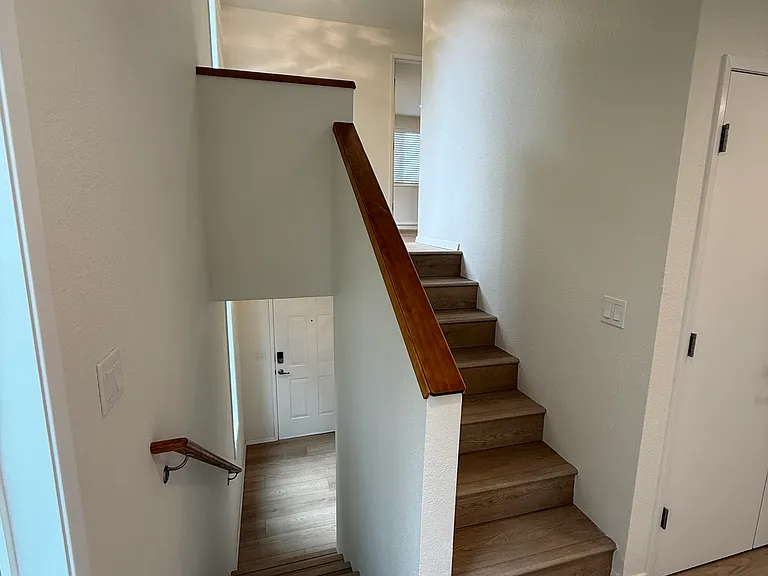 Main level living leads to the primary suite. The well lighted landing (a perfect sunny morning reading nook?) leads into huge bedroom and full bath, plus additional storage with a built in (kitchen height!) double vanity.