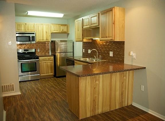 Kitchen has custom cabinets, copper backsplash, bar seating, and tons of storage.  Comes complete with Refrigerator, Microhood, Dishwasher, Disposal, gas cooking and pantry!