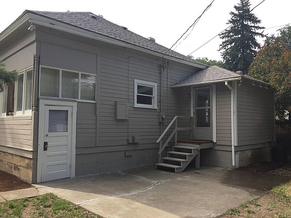 Backyard with patio, grass and two sheds