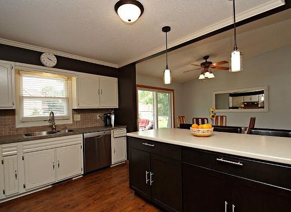 The remodeled kitchen with a huge island is perfect for entertaining. There is convenient access to the  back yard through the patio door to the large paver patio.