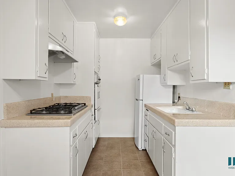 Kitchen with a Refrigerator, Range Stovetop, and Oven