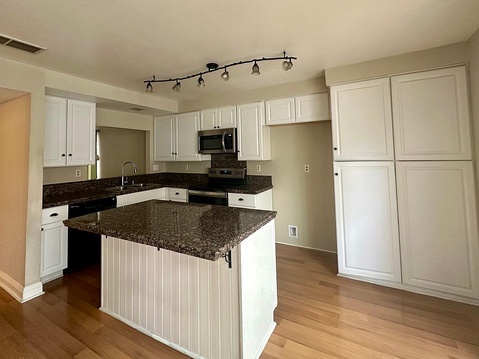 Kitchen with an island containing storage cabinets.